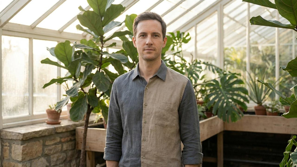 Man standing calmly in a sunlit botanical greenhouse, representing AndroWeight men's daily wellness