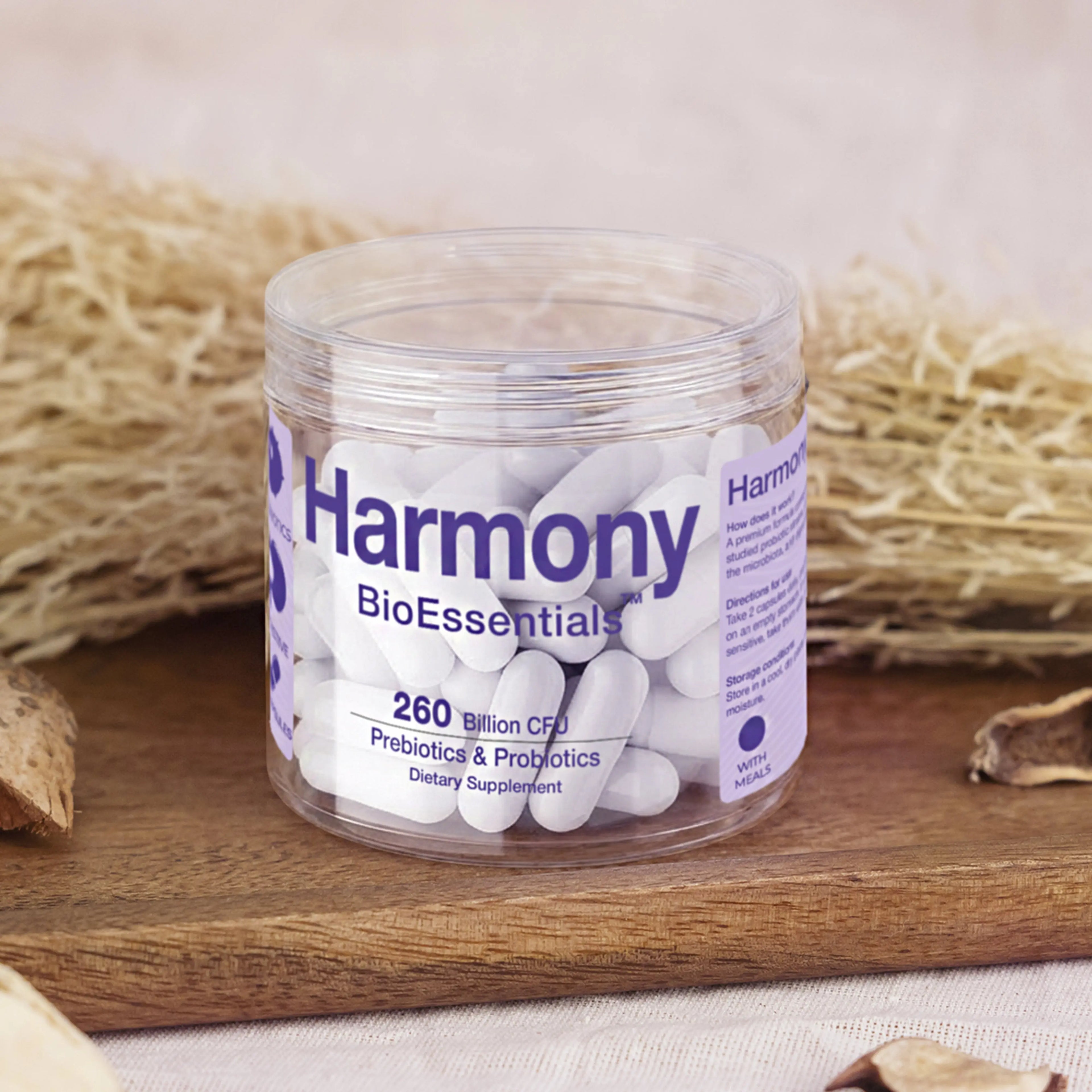 Harmony prebiotics and probiotics supplement capsules in a clear jar on a wooden tray
