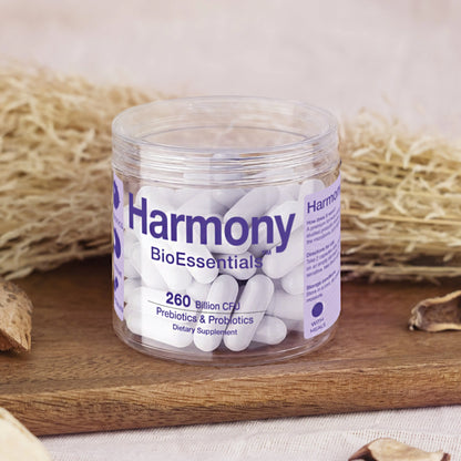 Harmony prebiotics and probiotics supplement capsules in a clear jar on a wooden tray